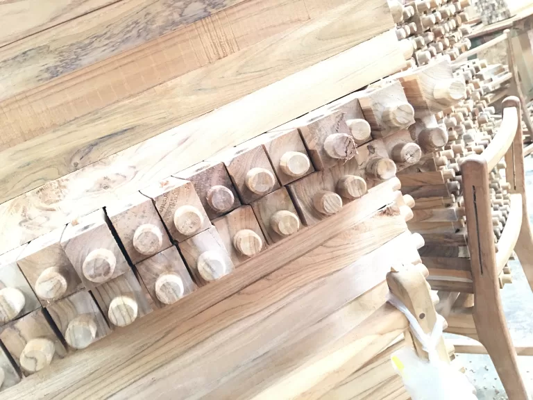 Sized teak components stacked and waiting for assembly