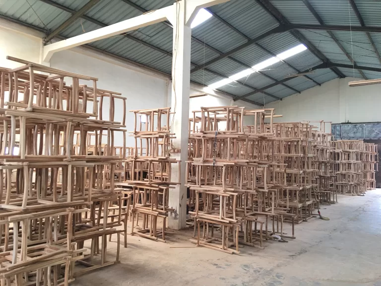 Boards and parts stored on the workshop floor