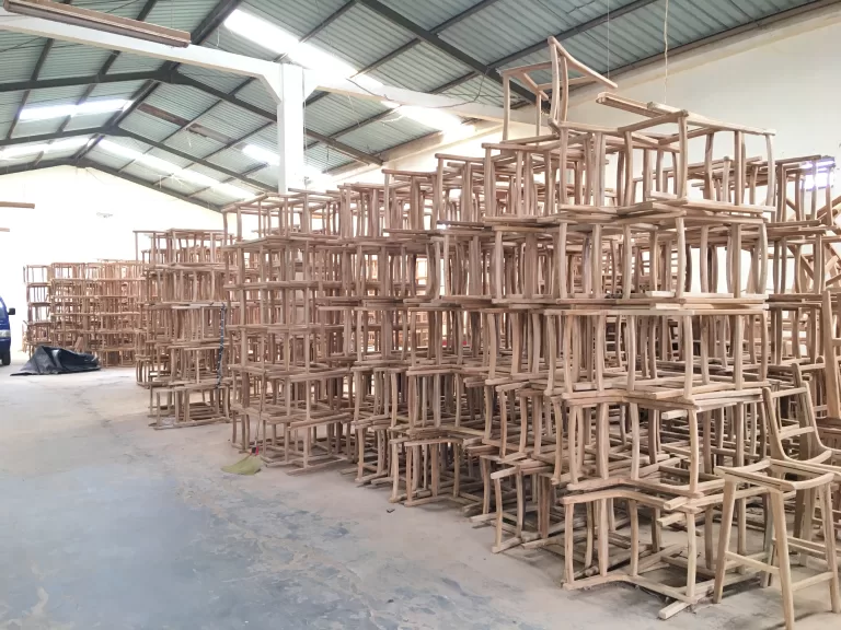 Benches and stacked parts under the workshop roof