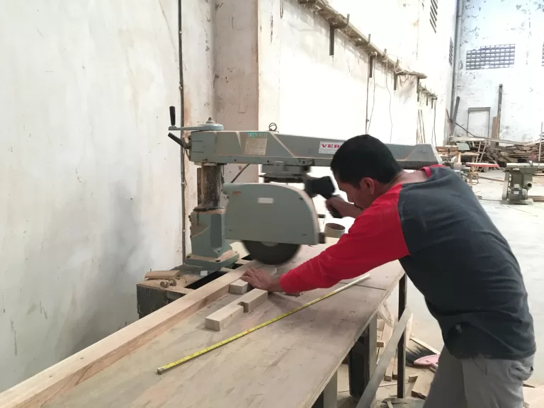 Part-making benches with wooden parts in progress at the workshop