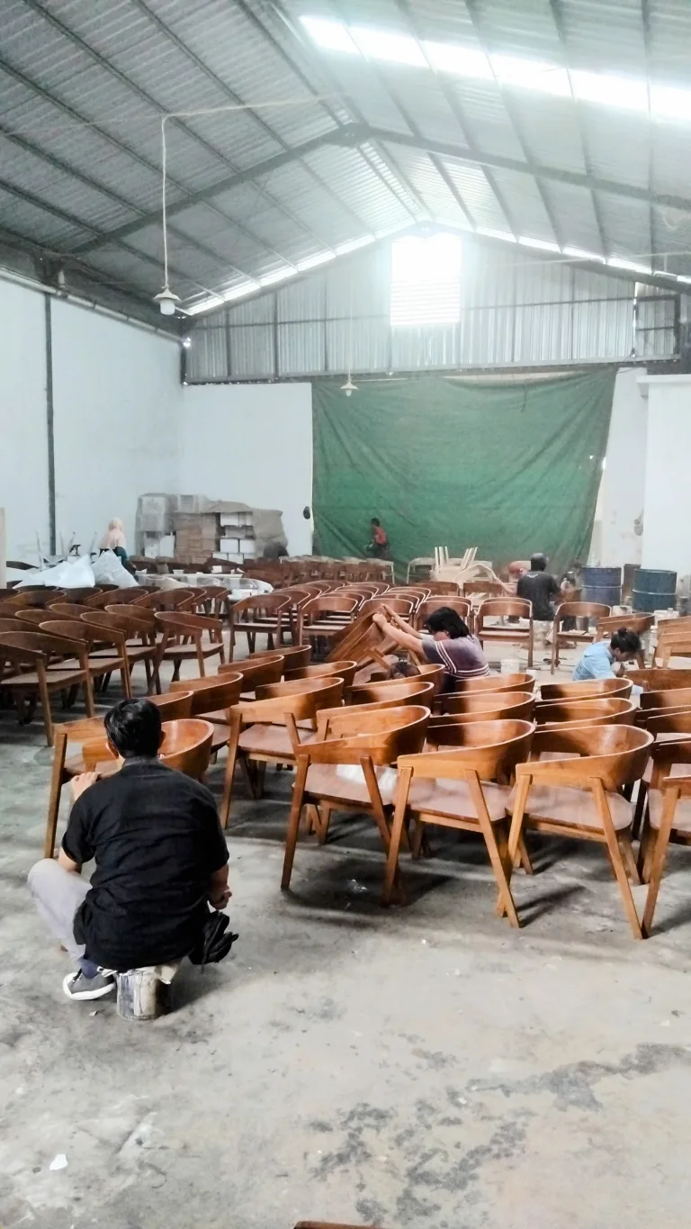 Chairs with woven seats arranged across the workshop floor