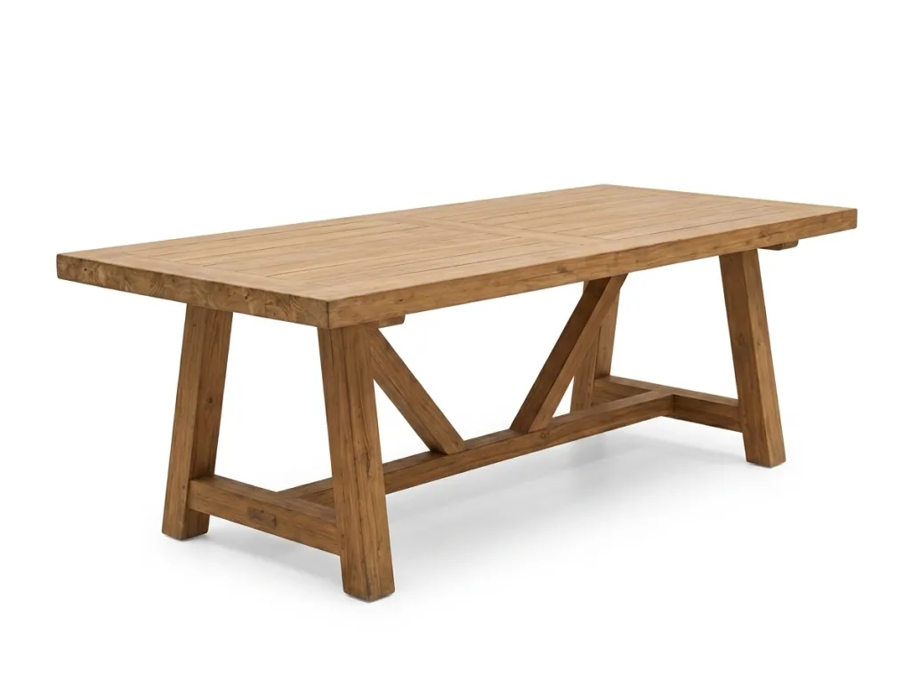 Dining table with a thick wooden plank top on a crossed trestle base, on a white background