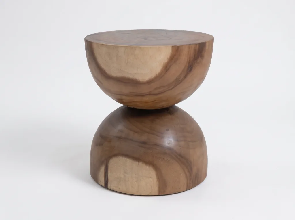 Suar wood stool shaped like an hourglass from two rounded sections, with wavy grain running through the timber, on a plain light background